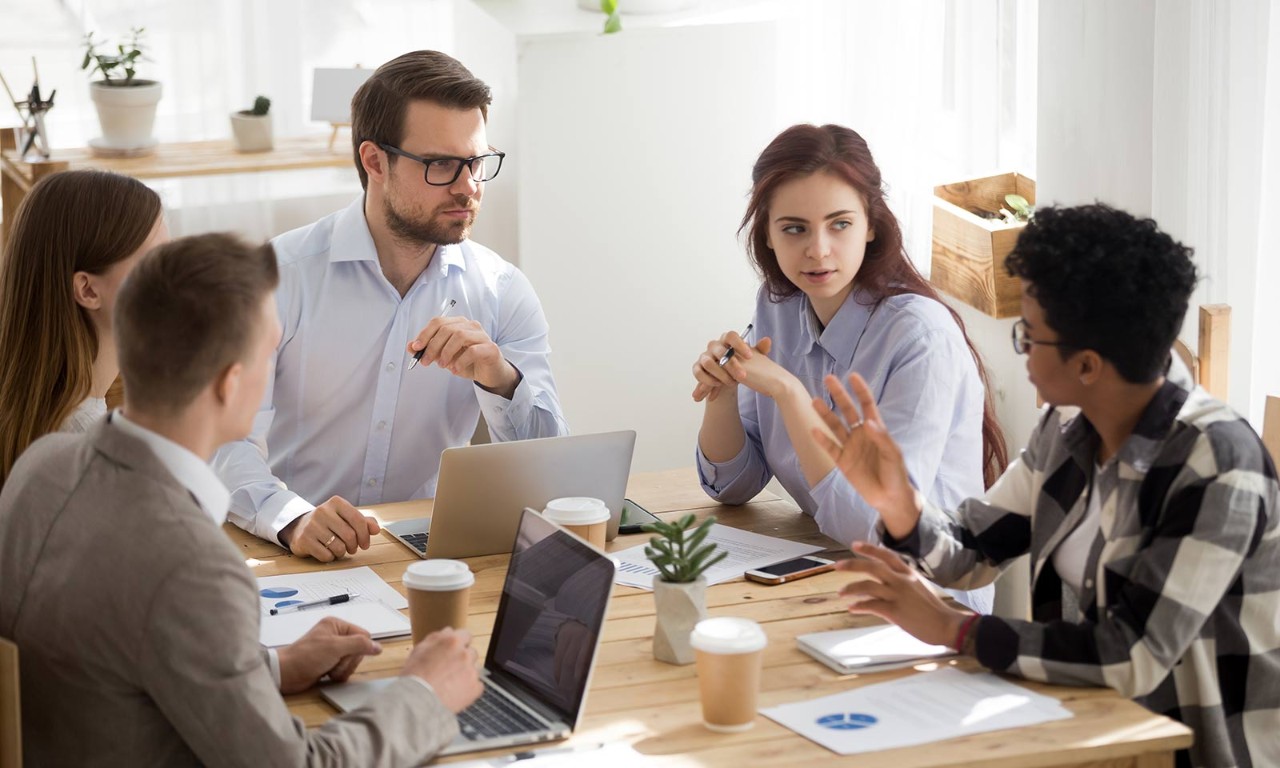 A group of AppSec employees sitting around a table discussing their different needs